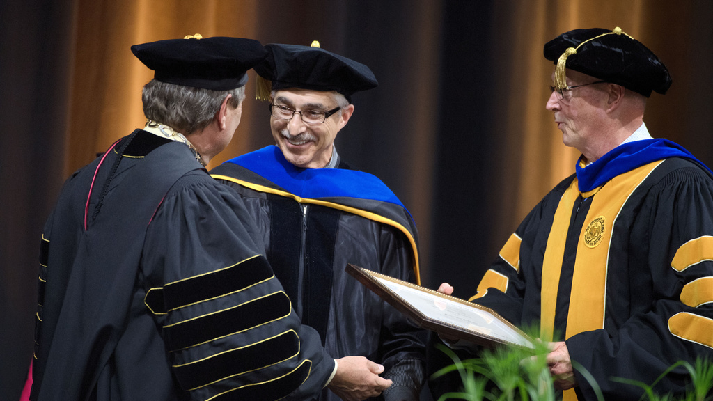 Martin Sepulveda receiving honorary degree from President Harreld and Dean Keller